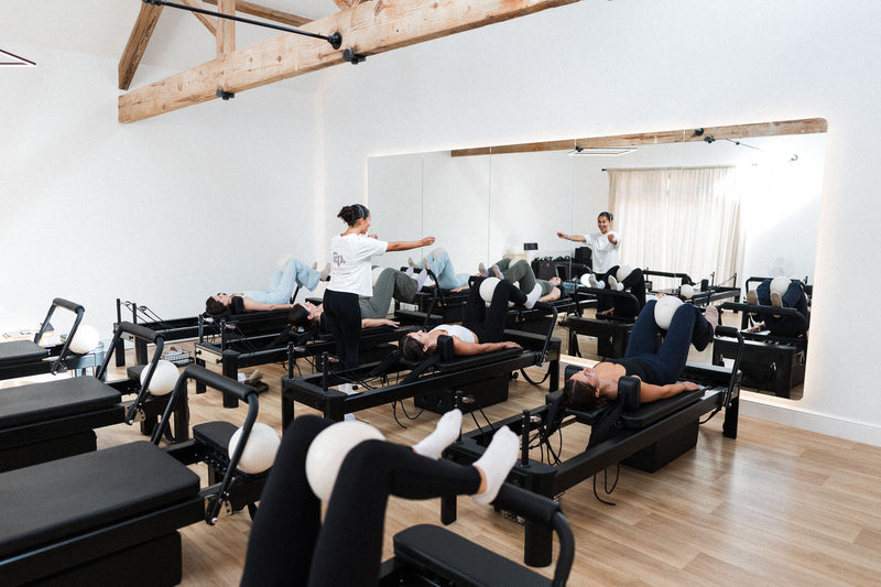 Clients using reformer straps at the Woodbury studio