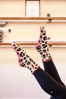 Hot Stuff leopard and chilli Pilates grip socks worn with black leggings in the Radiant studio
