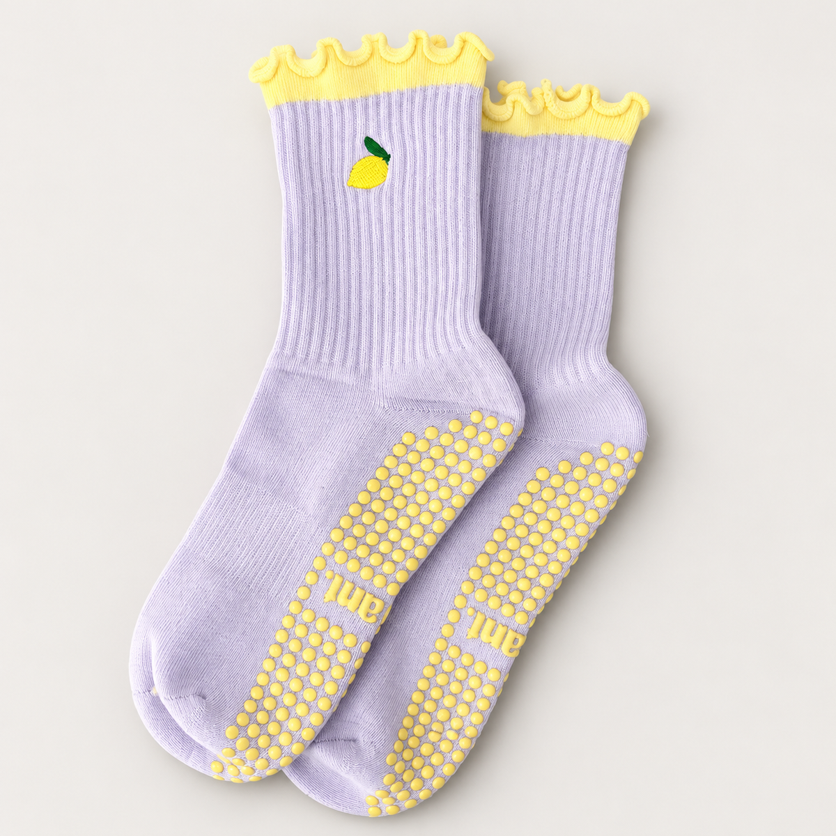 Main Squeeze Pilates grip socks in lilac & lemon, showing cuff details and dotted grip soles