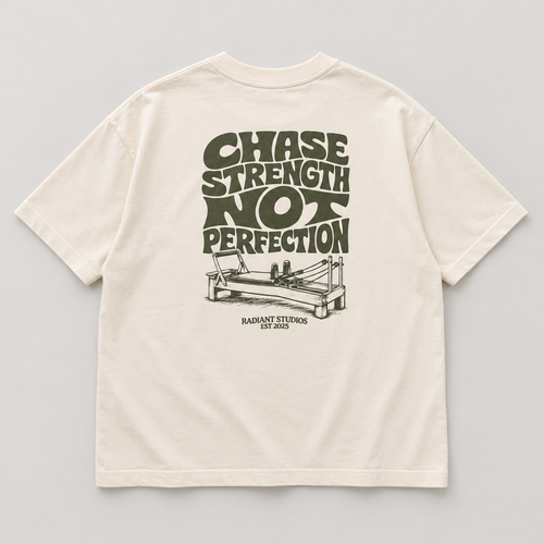 Back flat lay of cream oversized Radiant Pilates T-shirt with olive Chase Strength Not Perfection print and reformer illustration