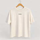 Front of cream oversized Radiant Pilates T-shirt on wooden hanger with small olive chest logo