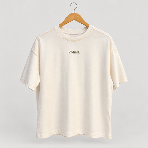 Front of cream oversized Radiant Pilates T-shirt on wooden hanger with small olive chest logo