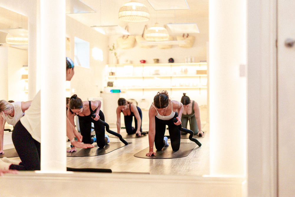 Group mat Pilates practice at Radiant Woodbury