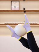 Main Squeeze Pilates grip socks - studio Pilates ball pose