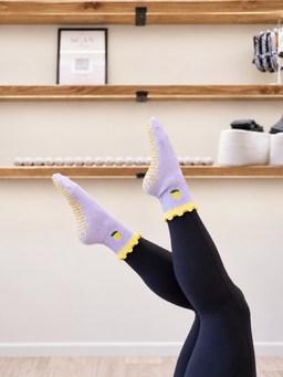 Main Squeeze Pilates grip socks - studio legs raised